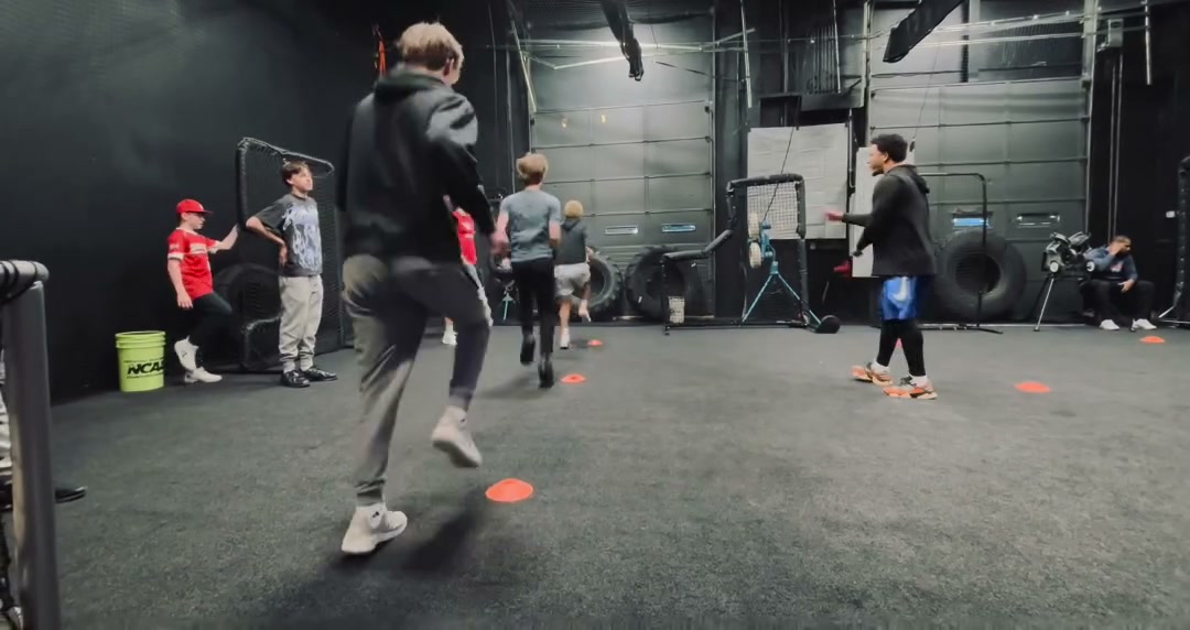 Athletes running footwork drills on the Tunnel Baseball training floor